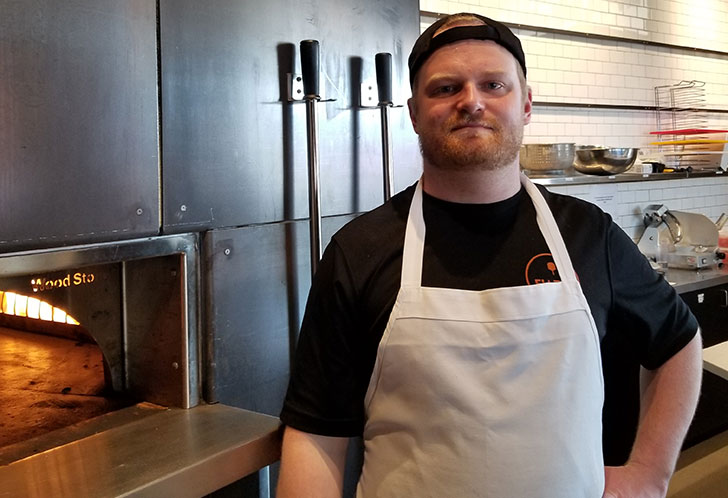 Fiazza's Pizza Cook Andrew standing in kitchen